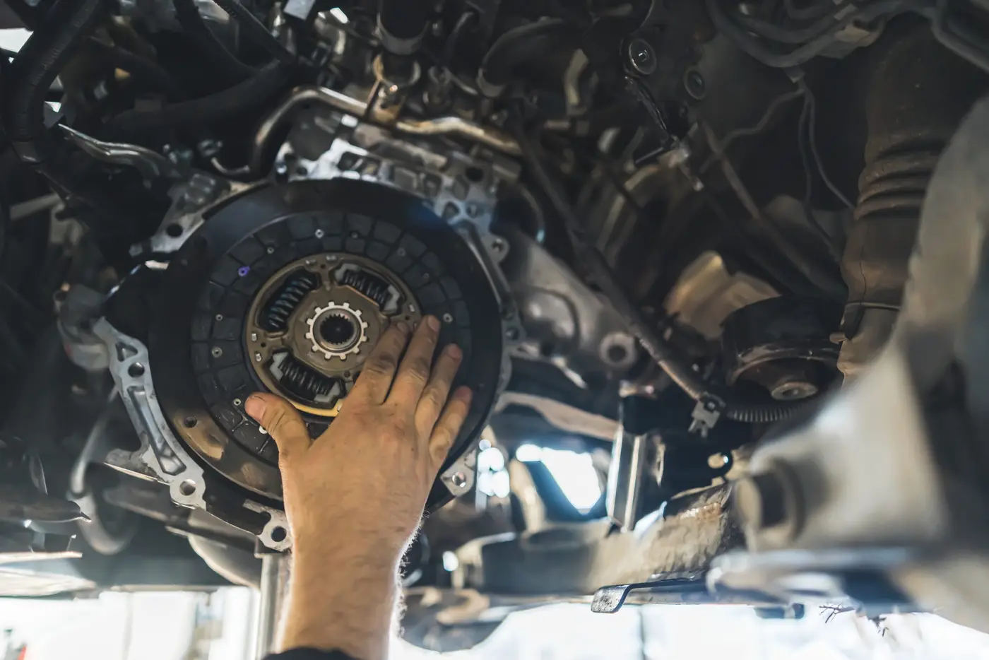 auto mechanic installing a new clutch kit for a car, closeup shot